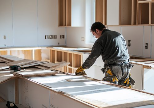 person-installing-new-cabinets-countertops-kitchen-renovation